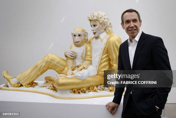 American artist Jeff Koons poses in front of "Michael Jakcson and Bubbles" on May 11, 2012 during an exhibition preview of his work at the Fondation...