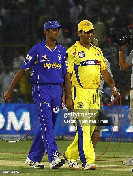 Rajasthan Royals captain Rahul Dravid and Chennai Super Kings captain M S Dhoni walks together after the toss at the ground as rain delayed play at...