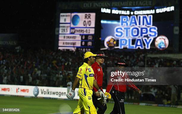 Chennai Super Kings captain M S Dhoni walks with umpires as rain delayed play at Sawai Man Singh Stadium on May 10, 2012 in Jaipur, India. Chasing...