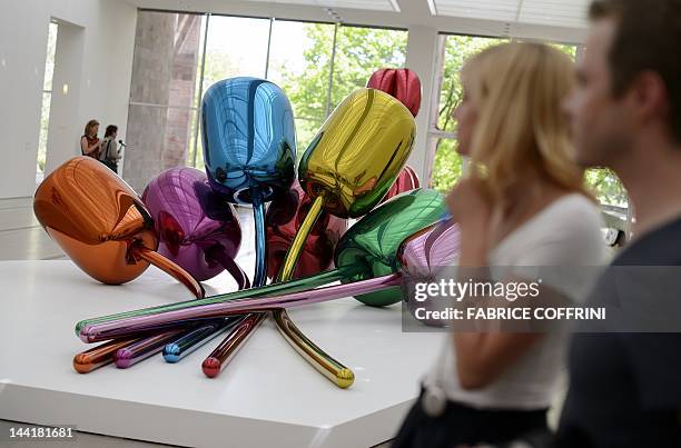 People visit on May 11, 2012 an exhibition preview of US artist Jeff Koons' works on display at the Fondation Beyeler museum in Basel. The Fondation...
