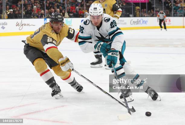 Alec Martinez of the Vegas Golden Knights pokes the puck away from Timo Meier of the San Jose Sharks during the third period at T-Mobile Arena on...