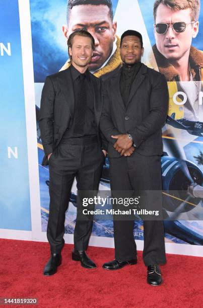 Actors Glen Powell and Jonathan Majors attend the Los Angeles premiere of "Devotion" at Regency Village Theatre on November 15, 2022 in Los Angeles,...