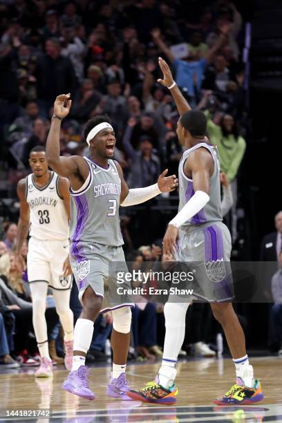 Terence Davis of the Sacramento Kings is congratulated by De'Aaron Fox after he made a basket against the Brooklyn Nets at Golden 1 Center on...