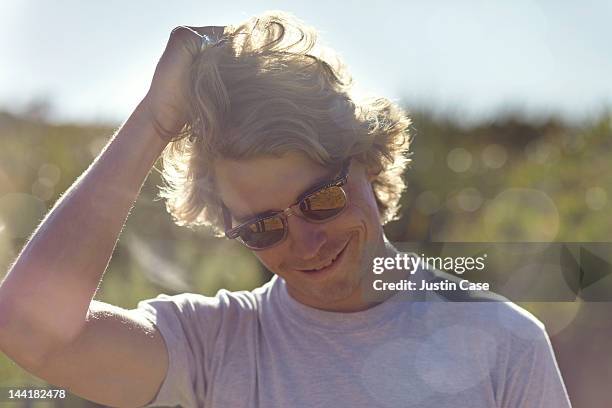 man wearing sunglasses grabbing his hair - man with gray hair stock pictures, royalty-free photos & images