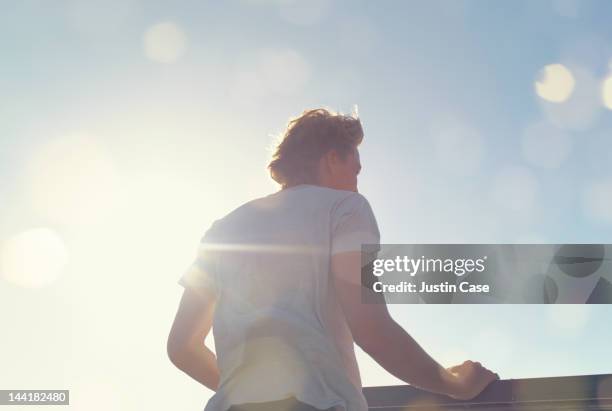 portrait of a man standing in sunshine - high key stock pictures, royalty-free photos & images