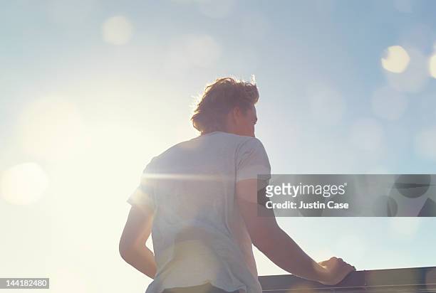 portrait of a man standing in sunshine - desbotado imagens e fotografias de stock