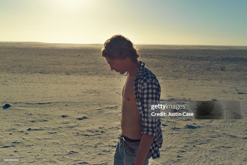 A man taking a walk on the beach