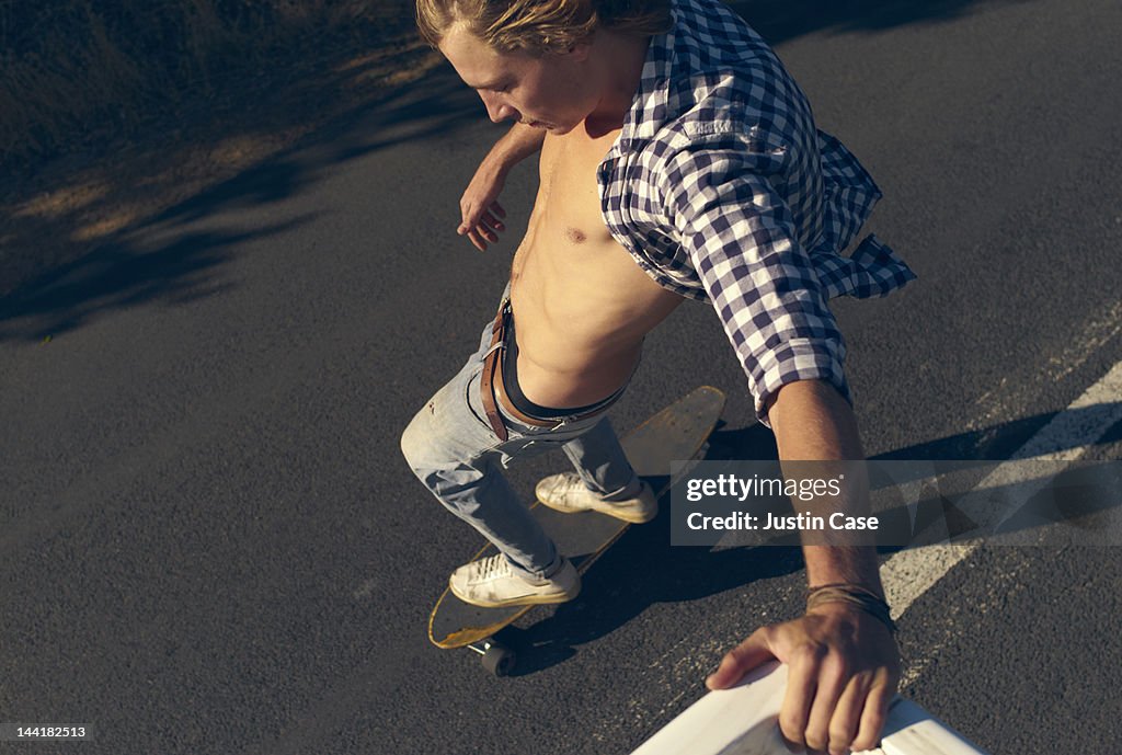 Man riding his skateboard grabbing a pick up truck