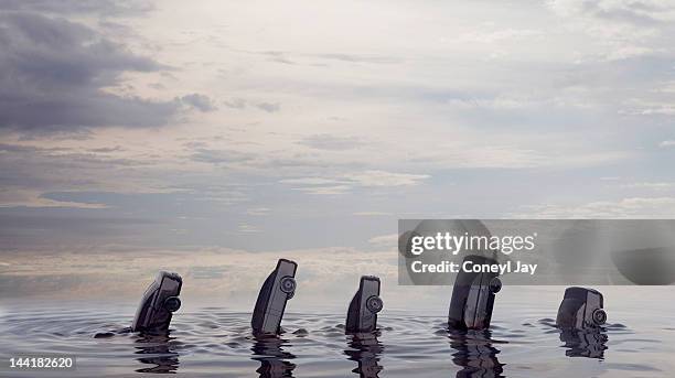 cars sinking in ocean of crude oil - llandysul stock pictures, royalty-free photos & images