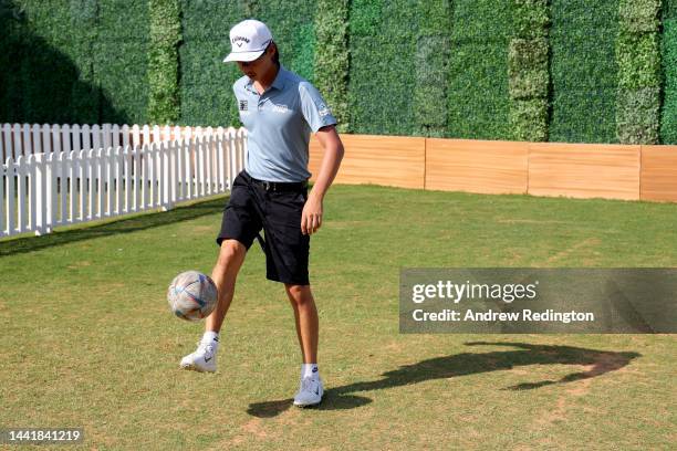 Min Woo Lee of Australia plays football prior to the DP World Tour Championship on the Earth Course at Jumeirah Golf Estates on November 16, 2022 in...