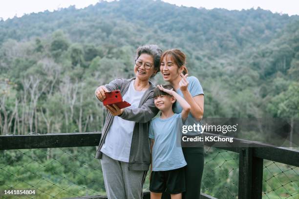 asian chinese family having great time. - chinese family taking photo at home stock pictures, royalty-free photos & images