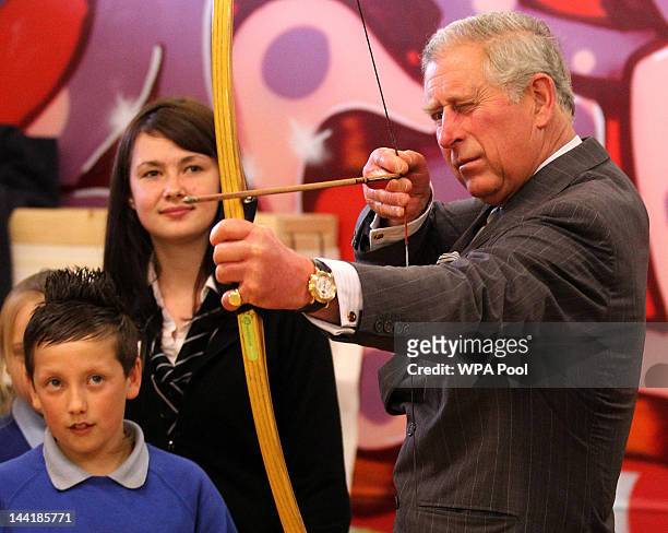 The Duke of Rothesay tries his hand at archery has a shot archery watched by Jason Wilson and archery coach Jim McPike during a visit to the North...