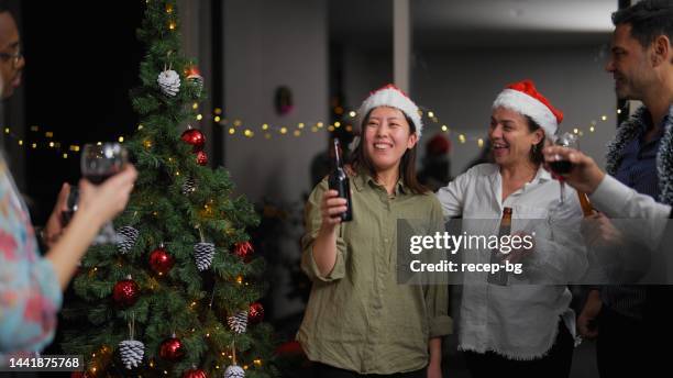 businesswoman giving small speech before celebratory toasting while having christmas party after work at office - glass bottle white bg stock pictures, royalty-free photos & images