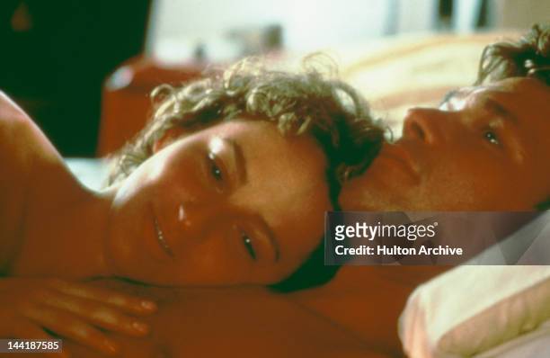 American actors Patrick Swayze and Jennifer Grey enjoy a post-coital moment in the film 'Dirty Dancing', 1987.