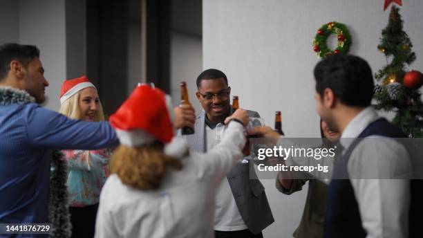 group of multiracial business people enjoying eating pizza and celebrating christmas together at office after work - glass bottle white bg stock pictures, royalty-free photos & images