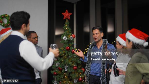 businessman giving small speech before celebratory toasting while having christmas party after work at office - christmas office party stock pictures, royalty-free photos & images