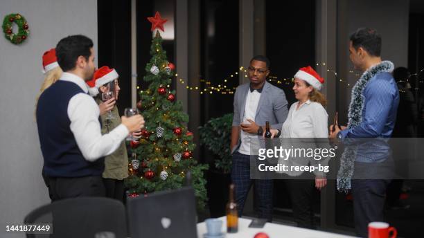 businesswoman giving small speech before celebratory toasting while having christmas party after work at office - glass bottle white bg stock pictures, royalty-free photos & images