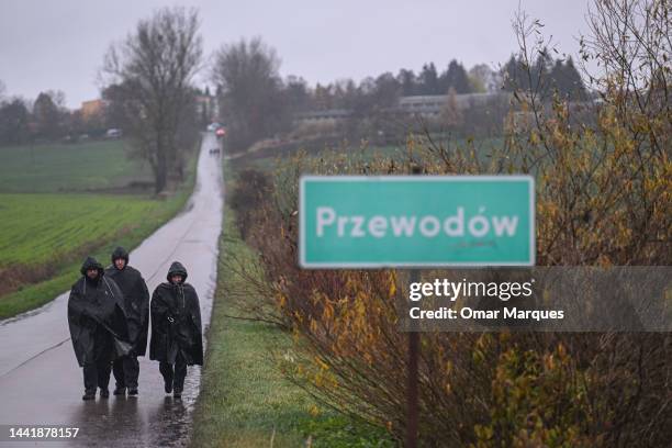 Police officers wear a rain coat as they search and patrol around the blast site on November 16, 2022 in Przewodow , Poland. Poland convenes a...