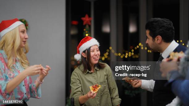 group of multiracial business people enjoying eating pizza and celebrating christmas together at office after work - glass bottle white bg stock pictures, royalty-free photos & images