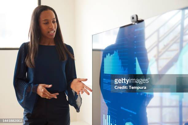 tall attractive black businesswoman imparts information at business presentation - powerpoint stock pictures, royalty-free photos & images