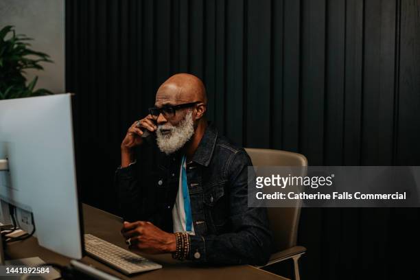 a busy male receptionist answers the phone - bell telephone company stock pictures, royalty-free photos & images