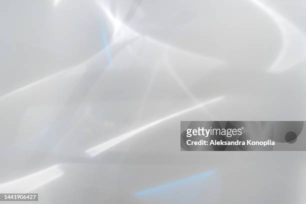 blurred dreamy surreal rainbow light refraction texture overlay effect on white wall - glazed stock pictures, royalty-free photos & images