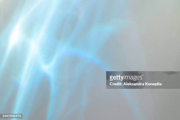 surreal rainbow laser light refraction texture overlay effect on white wall - digital composite stock-fotos und bilder