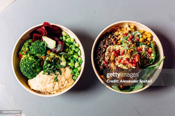 vegan bowls with various vegetables, hummus and seeds on the table, directly above view - quinoa and chickpeas stock pictures, royalty-free photos & images
