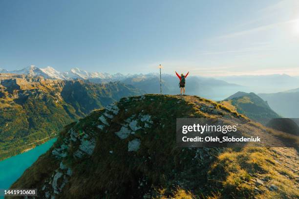 man hiking  on the background of interlaken in swiss alps near road sign - signaling pathways stock pictures, royalty-free photos & images