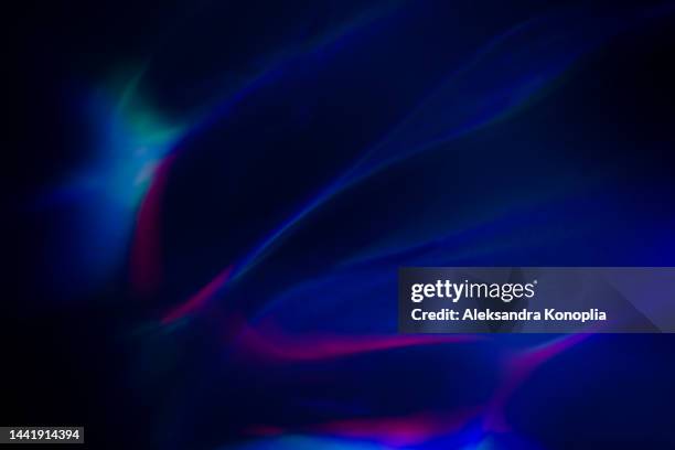 colorful neon rainbow aurora borealis or laser light leaks texture on black background - aura fotografías e imágenes de stock