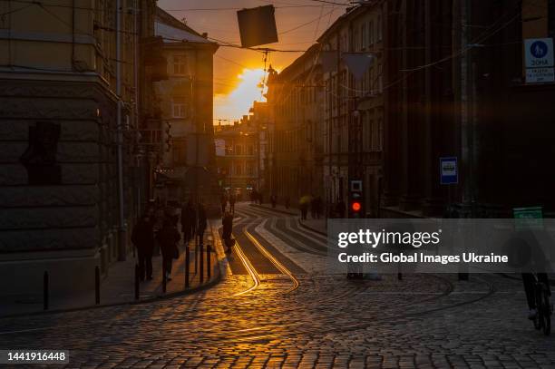 The sun setting on Ruska Street, view towards Rynok Square on October 12, 2022 in Lviv, Ukraine. The central square in Lviv, the historical heart of...