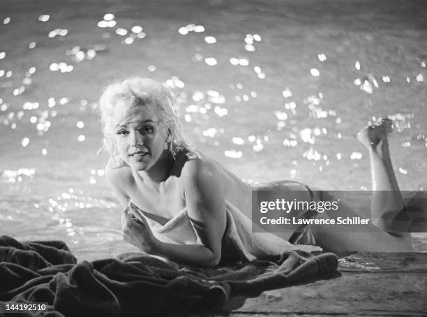 American actress Marilyn Monroe lies topless on the deck of a pool during the filming of 'Something's Got to Give' , Los Angeles, California, May 23,...