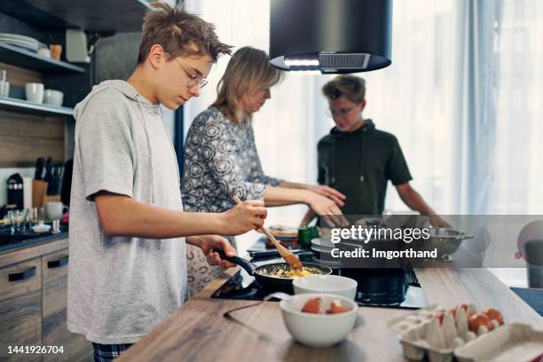 mother and sons preparing breakfast together - geographical locations stock pictures, royalty-free photos & images