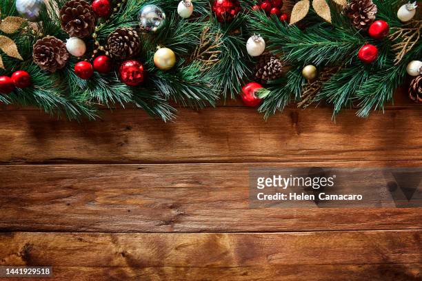 top view of christmas garland on rustic wooden table with copy space - christmas background copy space stock pictures, royalty-free photos & images
