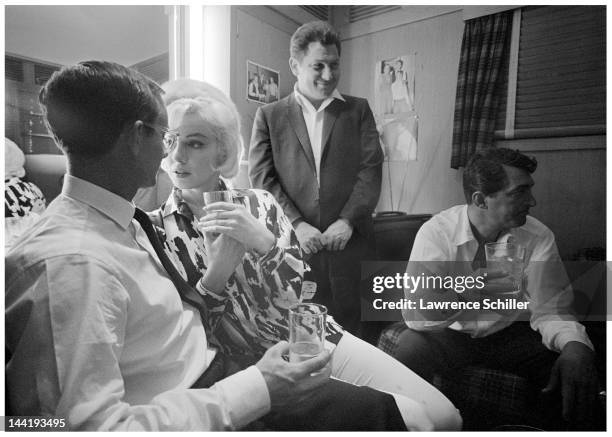 American actress Marilyn Monroe celebrates her birthday with, among others, her co-stars, actors Wally Cox and Dean Martin , in Martin's dressing...