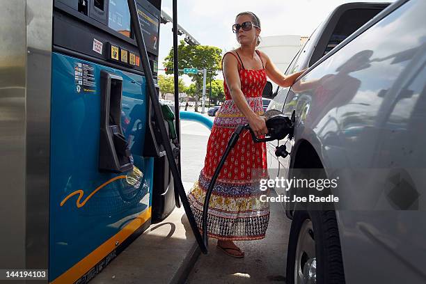 Lucy Crawford puts gas into her vehicle at a Valero station on May 11, 2012 in Miami, Florida. Reports indicate that gasoline prices have dropped 5...