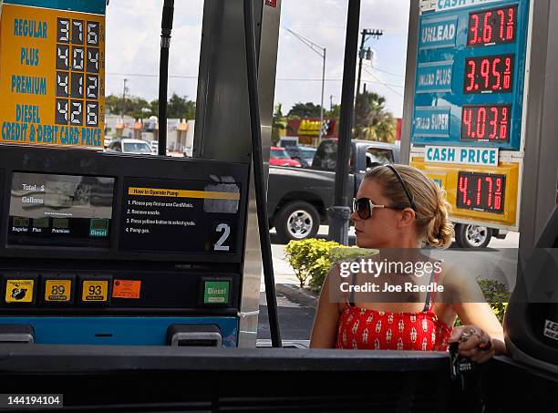 Lucy Crawford puts gas into her vehicle at a Valero station on May 11, 2012 in Miami, Florida. Reports indicate that gasoline prices have dropped 5...