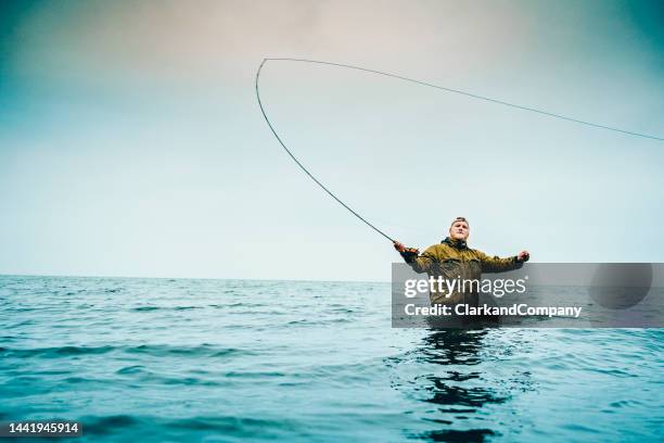 fly fishing in the baltic sea in denmark - fishing line stock pictures, royalty-free photos & images