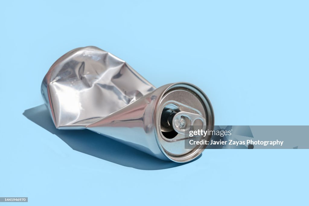 Crumpled Aluminum Can On Blue Background