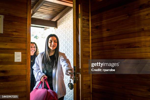 girlfriends traveling at the door arriving from trip - escape the room event stock pictures, royalty-free photos & images