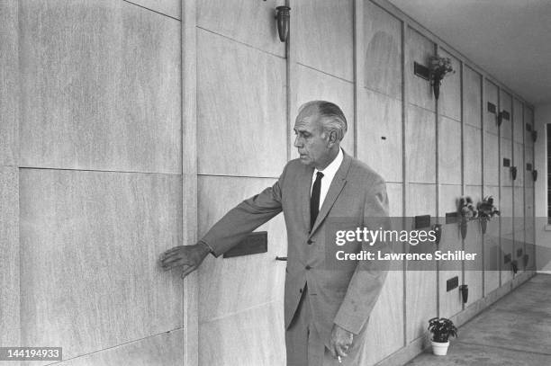 An unidentified man holds a cigarette as he stands beside the soon-to-be crypt of recently deceased American actress Marilyn Monroe at the Westwood...