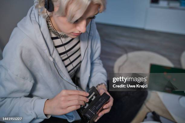 young woman listening to music - personal stereo stock pictures, royalty-free photos & images