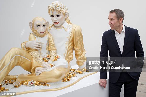 Artist Jeff Koons looks at 'Michael Jackson and Bubbles' during the 'Jeff Koons' exhibition preview at the Fondation Beyeler on May 11, 2012 in...