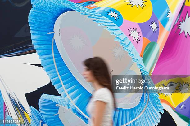 Visitor walks past an artwork by Jeff Koons during the 'Jeff Koons' exhibition preview at the Fondation Beyeler on May 11, 2012 in Basel,...