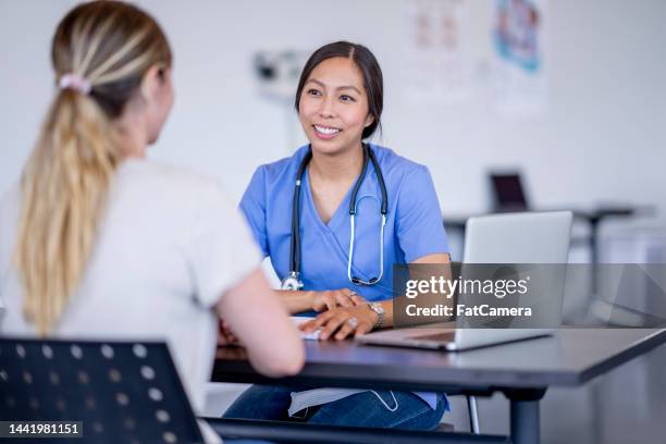 doctor meeting with a patient - gp practice stock pictures, royalty-free photos & images