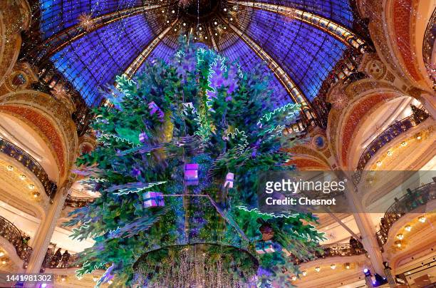 Giant decorated Christmas tree stands tall under the great dome of the Galeries Lafayette department store for Christmas and New Year celebrations on...