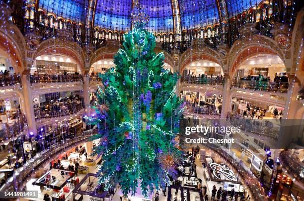 Giant decorated Christmas tree stands tall under the great dome of the Galeries Lafayette department store for Christmas and New Year celebrations on...