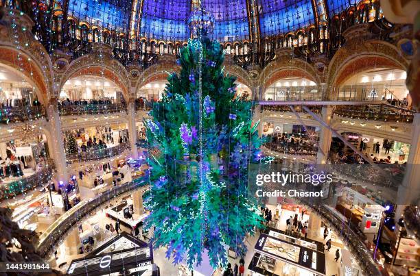 Giant decorated Christmas tree stands tall under the great dome of the Galeries Lafayette department store for Christmas and New Year celebrations on...