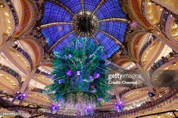 Giant decorated Christmas tree stands tall under the great dome of the Galeries Lafayette department store for Christmas and New Year celebrations on...