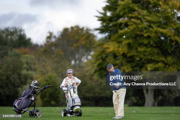 senior golfers playing a round of golf. - northern european descent stock pictures, royalty-free photos & images